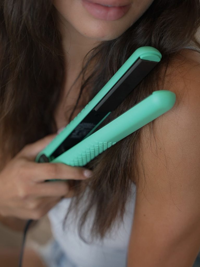 Woman using Takkra flat iron